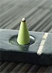 Incense cone burning in incense holder