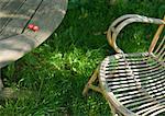 Wooden table and chair, two cherries on edge of table