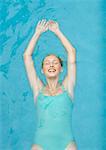 Young woman floating on back in pool