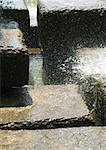 Water splashing over stones blocks, close-up