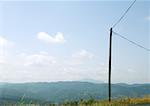 Electric post, mountainous landscape in background