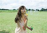 Girl blowing bubbles outdoors