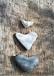 Heart shaped stones on wood surface