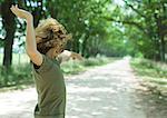 Boy playing in middle of dirt road