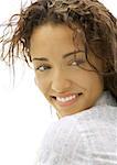 Woman looking over shoulder, smiling, close-up