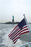 Statue of Liberty and American Flag, New York City, New York, USA