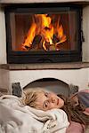 Woman Lying by Fireplace
