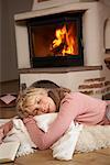 Woman Sleeping by Fireplace