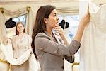 Woman in Bridal Boutique Looking at Price Tag