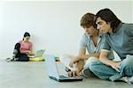 Teenagers using laptops