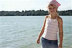 Little girl with bandana in front of a lake