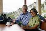 Senior adult couple is sitting in a restaurant, selective focus