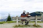 Senior adult couple sitting on a bench
