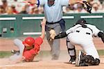 Baseball player sliding into home plate