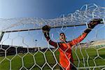 Keeper smiling through the net