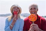 Portrait of Couple Eating Lollipops