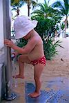 Girl Rinsing Feet at Water Faucet