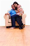 Young woman sitting on the laps of her grandfather and smiling