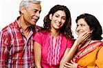 Close-up of a young woman and her parents smiling