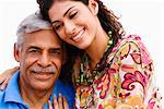 Portrait of a senior man with his granddaughter smiling