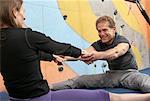 People Stretching in Climbing Gym