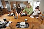 Mother and Children Setting Table