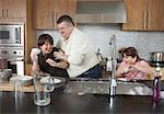 Father and Children Playing with Dishwater Suds