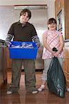 Boy and Girl with Recycling Bin and Garbage in Kitchen