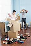 Couple Unpacking Shoes in New Home