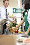 Man at Check-out Counter in Grocery Store