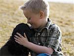 Boy with puppy outdoors