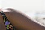 Close-up of a young woman sunbathing on the beach