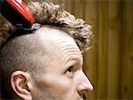 Close-up of man having head shaved