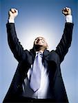 Businessman pumping fists in the air