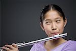 Close-up of a girl playing the flute