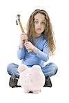 Portrait of a girl holding a hammer over a piggy bank