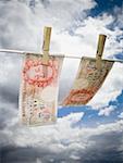 Low angle view of English paper currency pegged on a clothesline