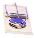 Close-up of a stack of coins on a mousetrap