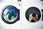 Man in dryer watching laundry