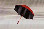 Low angle view of a red umbrella in the rain