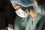 Profile of a female surgeon operating