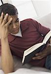 Close-up of a young man reading a book