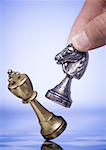 Close-up of a person's hand holding a chess piece