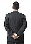 Rear view of a businessman hiding a jewelry box behind his back