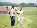 Senior woman and a senior man running in a field