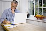 Mature man using a laptop computer