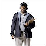 Coach with clipboard and headset smiling