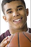 Close-up of a young man holding a basketball