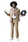 Man with an afro in beige suit listening to MP3 player