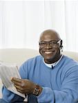 Portrait of a senior man holding a newspaper and smiling